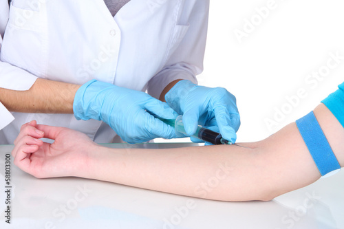 Nurse takes blood from the veins isolated on white