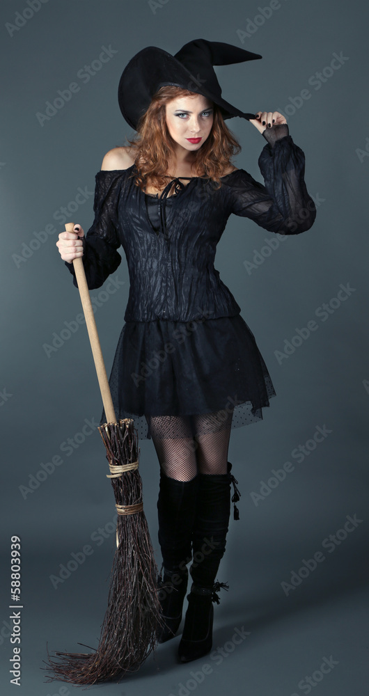 Halloween witch with broom on gray background Halloween witch with broom on gray background