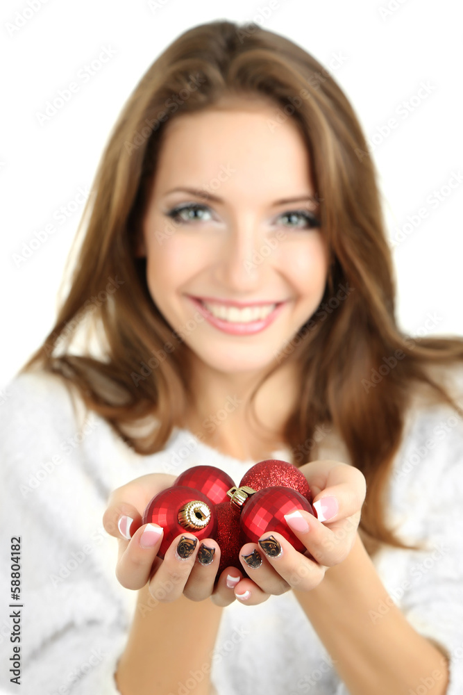 Beautiful smiling girl with Christmas toys isolated on white Beautiful smiling girl with Christmas toys isolated on white