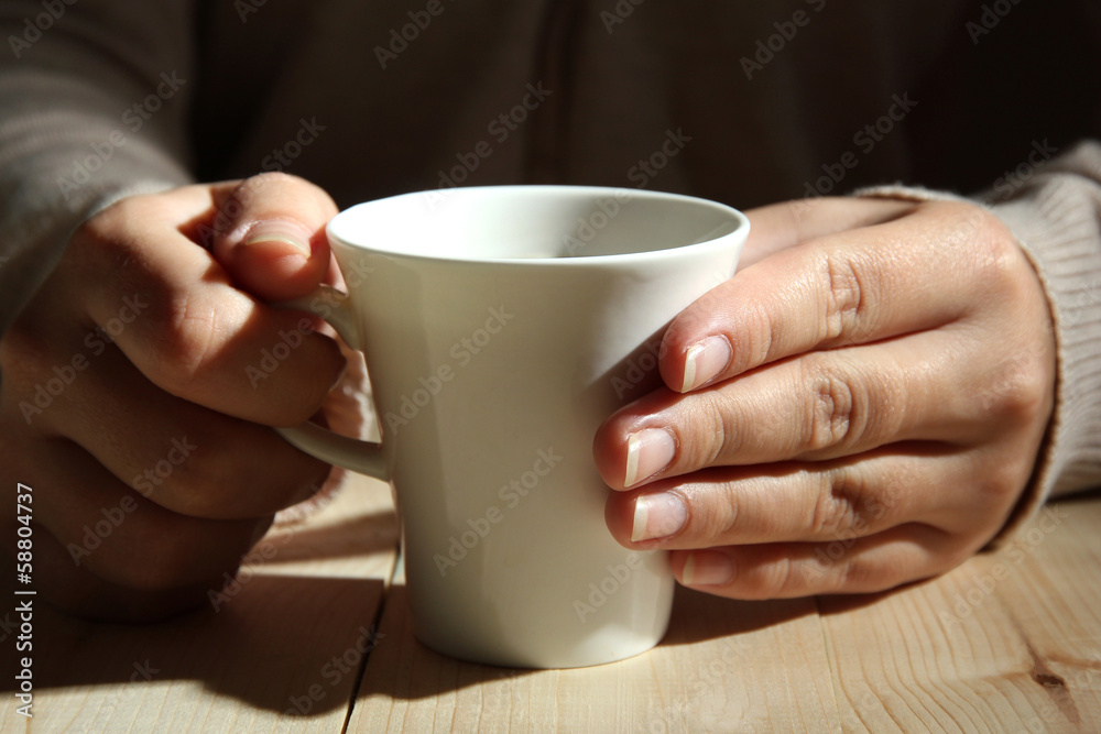 Hands holding mug of hot drink, close-up Hands holding mug of hot drink, close-up