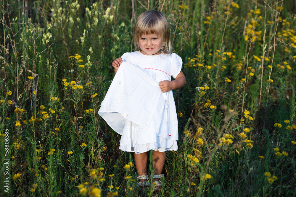 litle girl sitting in a meadow litle girl sitting in a meadow