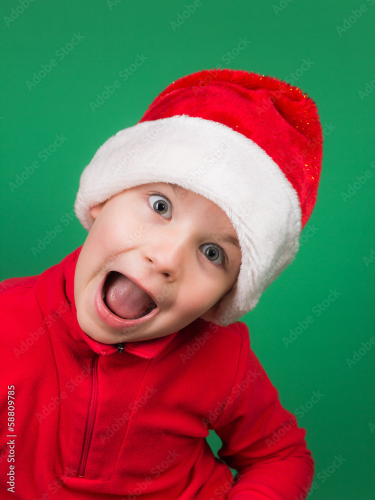 Santa boy playing on green backgroung Santa boy playing on green backgroung