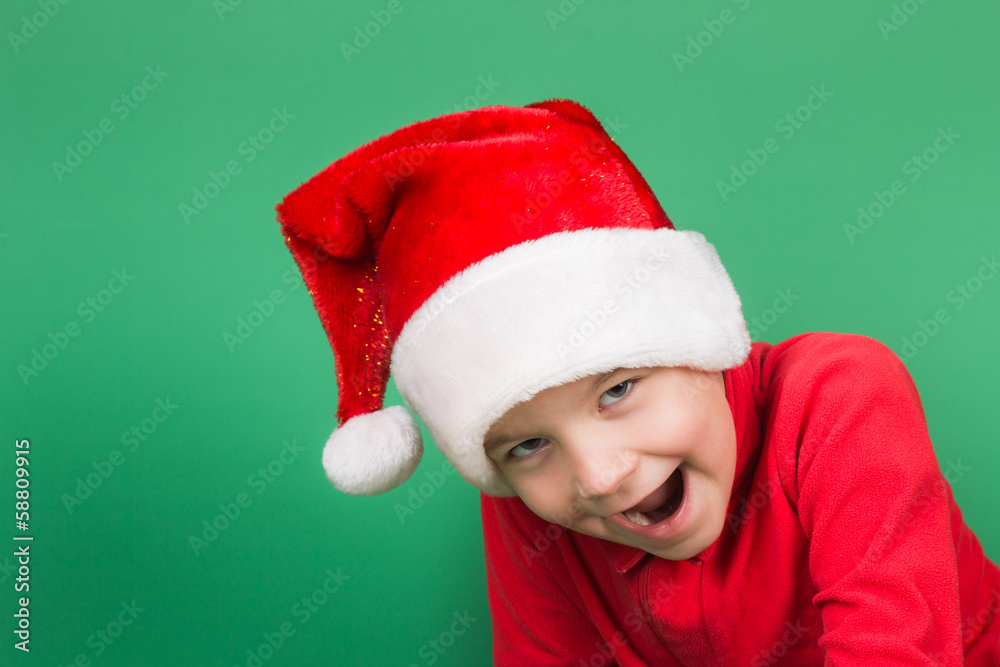 Santa boy playing on green backgroung Santa boy playing on green backgroung