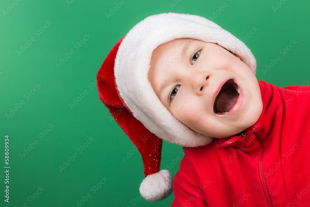 Santa boy playing on green backgroung Santa boy playing on green backgroung