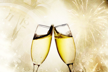 Champagne glasses and clock at midnight