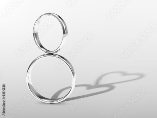 Silver Wedding Rings with shadows in shape of heart 