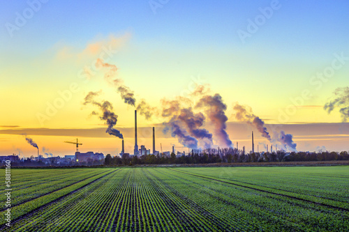 industry complex in Frankfurt in early morning with green fields