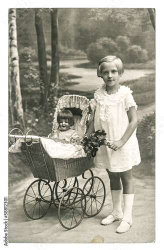 old photo of little girl with doll toy