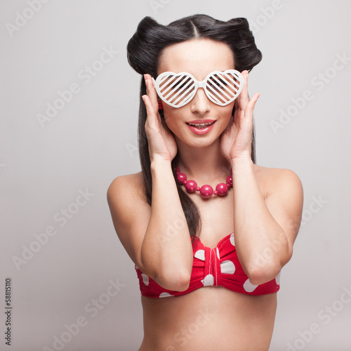 Pin Up model in heart shaped sunglasses photo