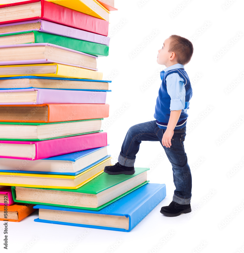 Little boy looking up to stacked big books Little boy looking up to stacked big books