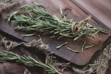 Bunch of fresh rosemary, rustic wooden background