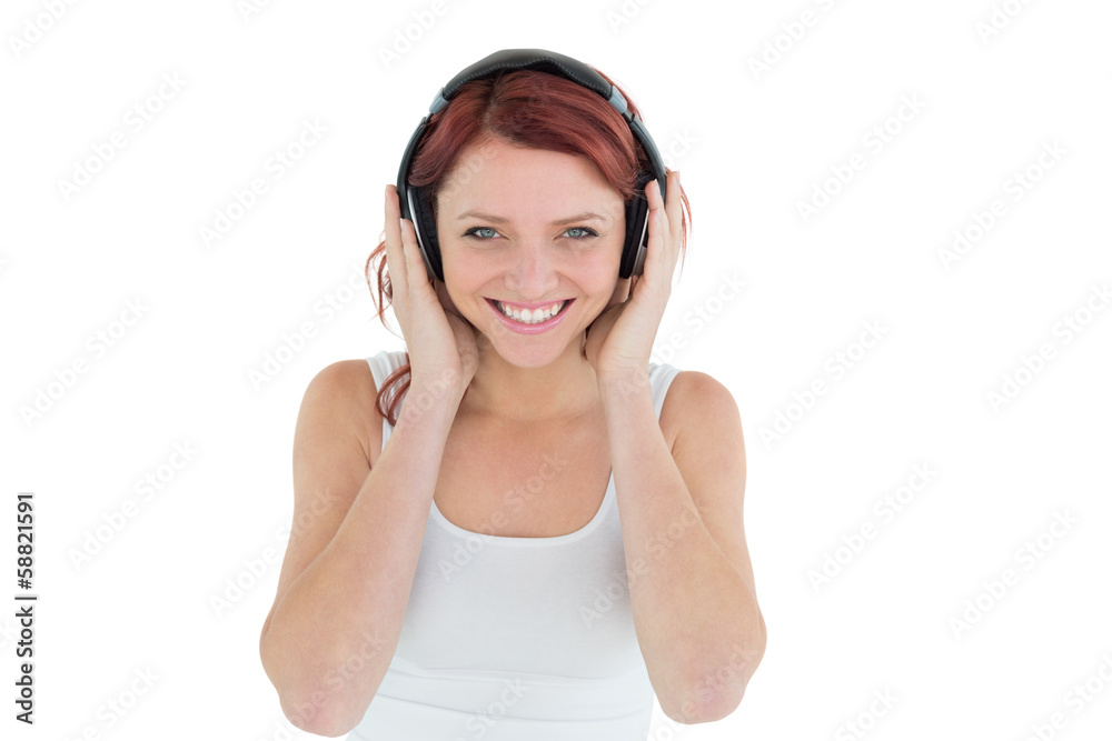 Beautiful casual woman enjoying music through headphones Beautiful casual woman enjoying music through headphones
