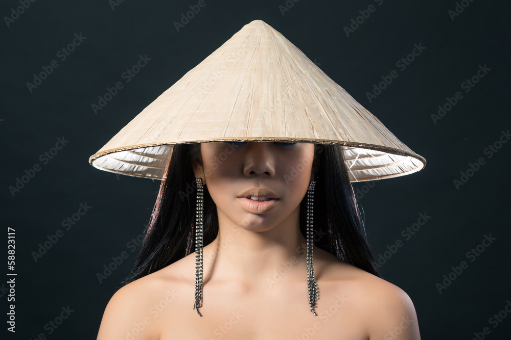 Beautiful brunette Asian woman with long black hair wears vietna Beautiful brunette Asian woman with long black hair wears vietna