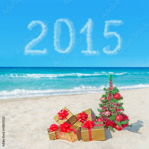 Christmas tree and gift boxes on sea beach. Concept for New Year