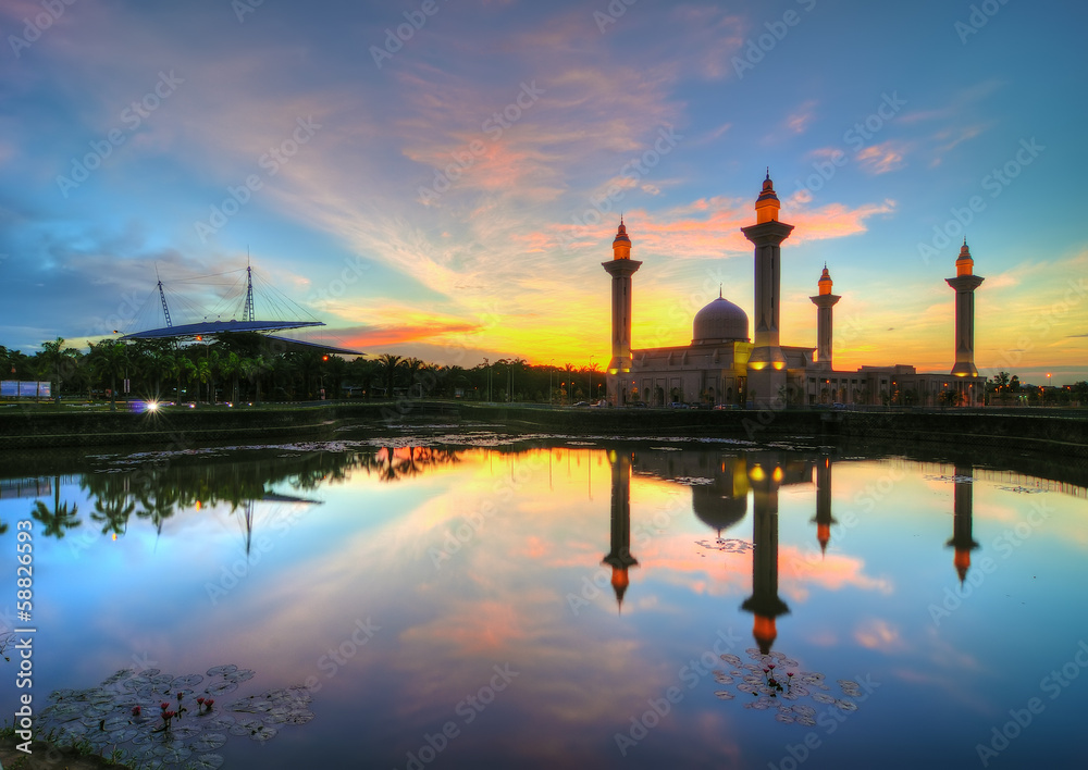 Reflection of a mosque at sunrise in Shah Alam, Malaysia.