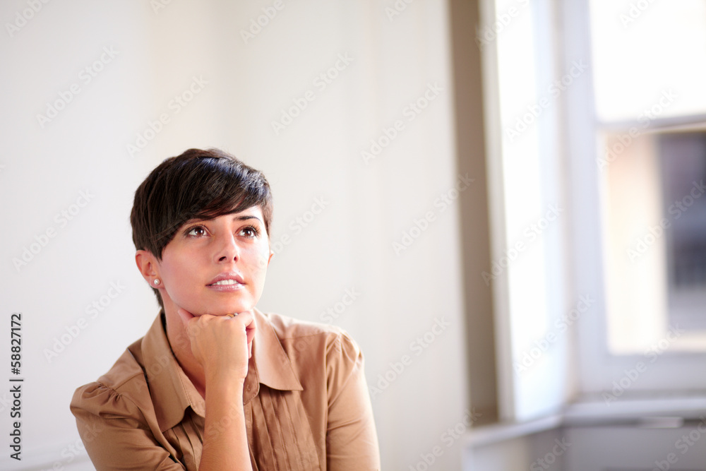 Lovely businesswoman on brown blouse thinking Lovely businesswoman on brown blouse thinking