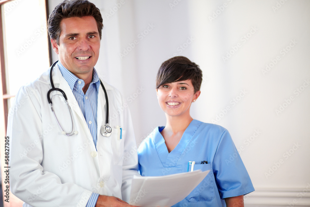 Handsome doctor and beautiful nurse smiling Handsome doctor and beautiful nurse smiling