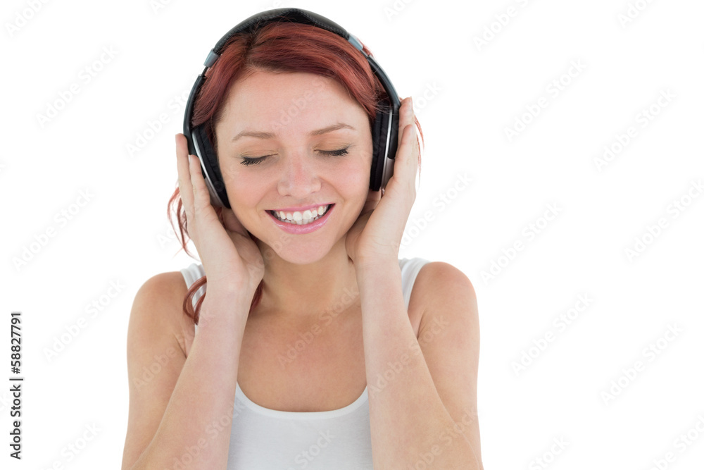 Beautiful woman enjoying music through headphones Beautiful woman enjoying music through headphones