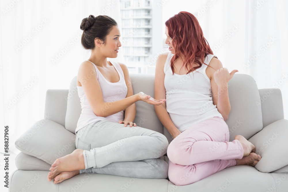 Relaxed female friends chatting in living room Relaxed female friends chatting in living room