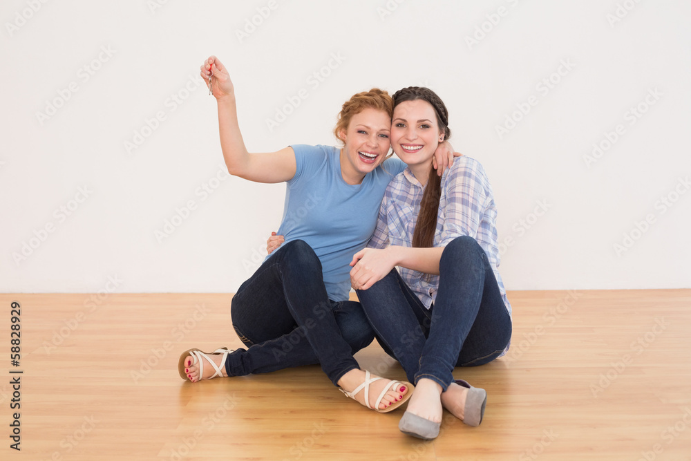 Cheerful female friends sitting in a new house Cheerful female friends sitting in a new house