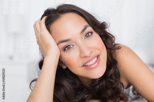 Close-up portrait of a pretty brunette in bed