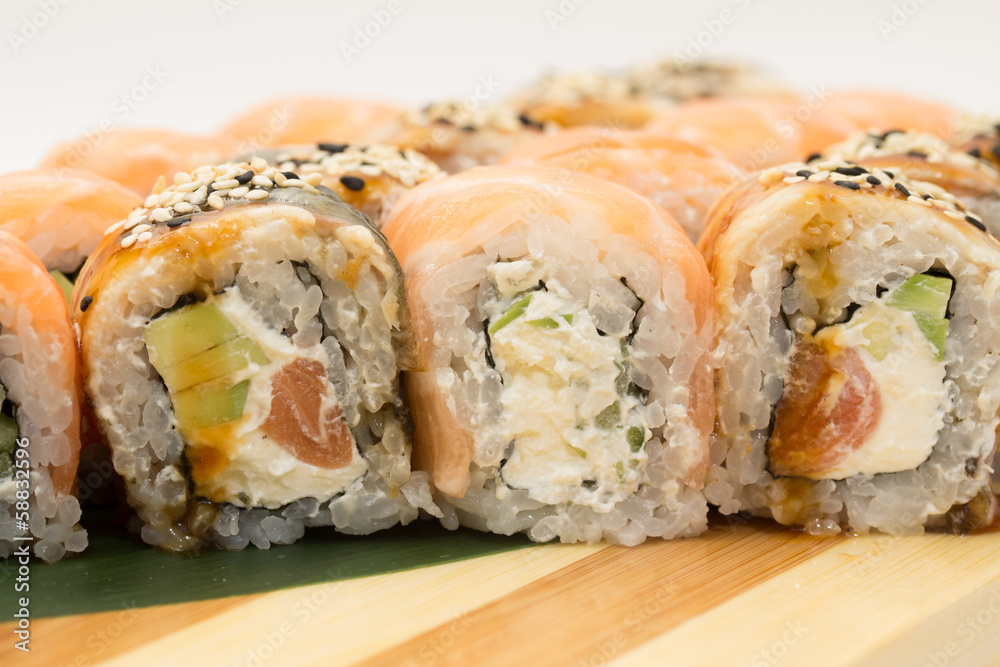 Sushi rolls on wooden plate