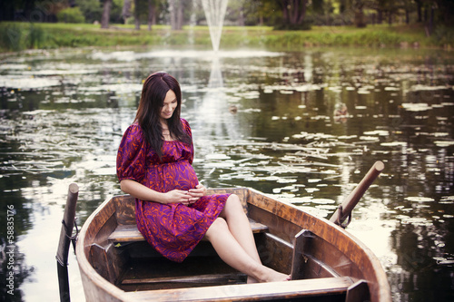 Pregnant woman sitting in boat © baltskars