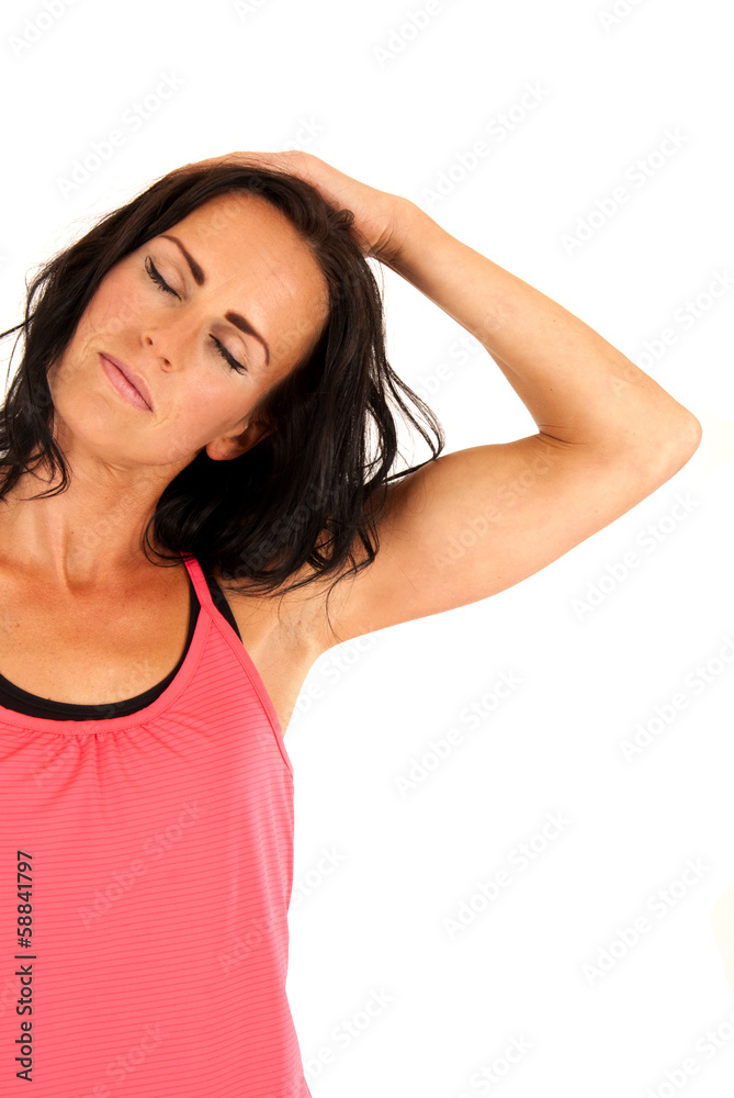 brunette fit woman stretching her neck out with eyes closed brunette fit woman stretching her neck out with eyes closed