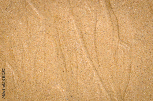 Watercourse on wet sand pattern of a beach