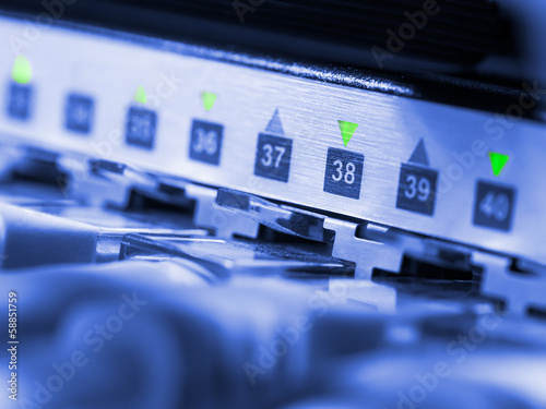 Closeup of network hub and cables blue toned
