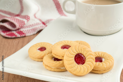 Strawberry jam sandwich biscuits with coffee cup