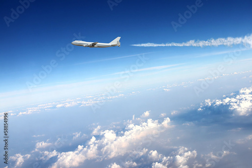 Airplane in clouds background.