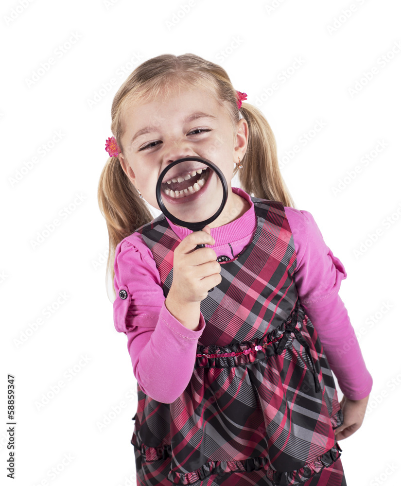 Funny girl showing teeth through a magnifying glass, isolated on Funny girl showing teeth through a magnifying glass, isolated on