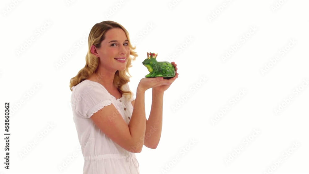 young woman kisses a frog young woman kisses a frog