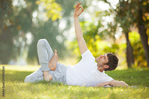 Man doing yoga exercises in the park