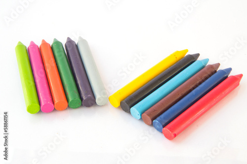 olored wax crayons isolated on white background.