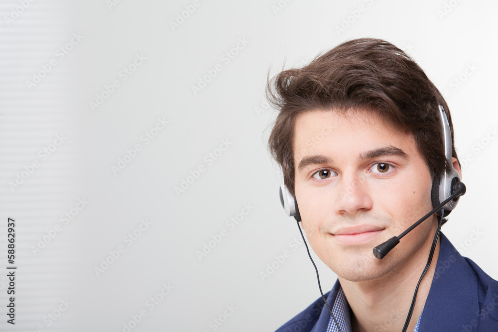 Portrait of a smiling call center employee wearing headset Portrait of a smiling call center employee wearing headset