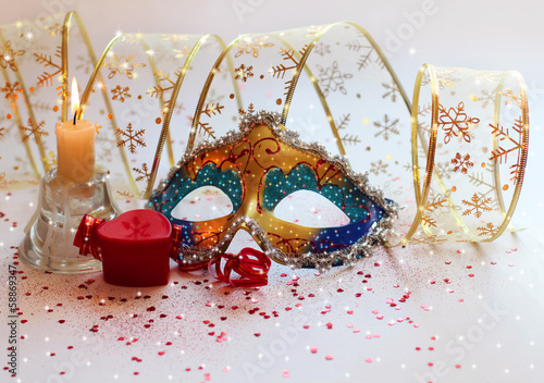Christmas composition with a mask, gifts and candles