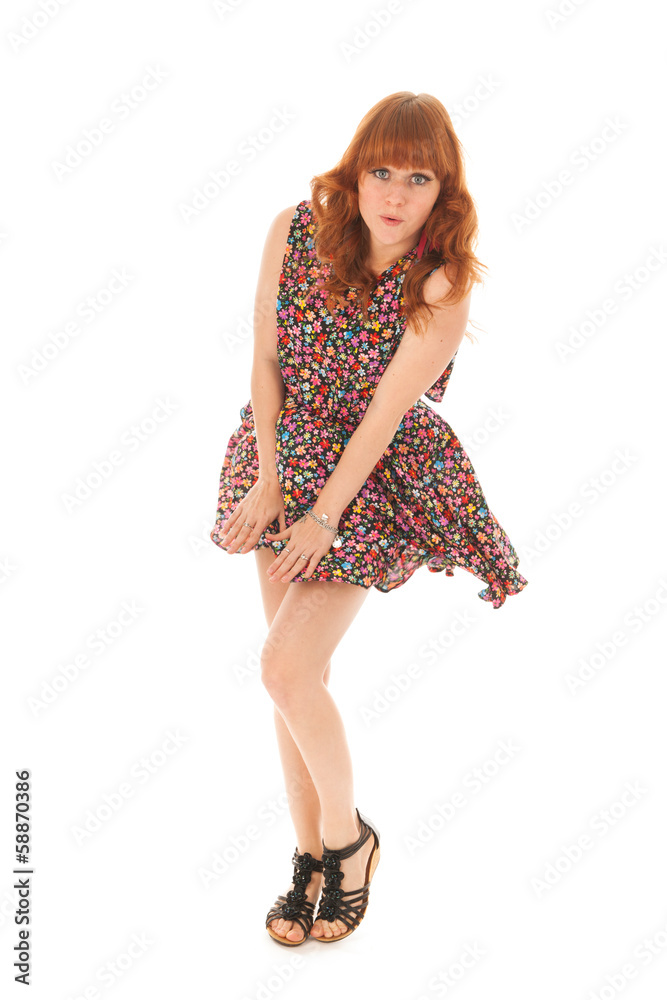 Red haired girl standing in wind isolated over white background Red haired girl standing in wind isolated over white background