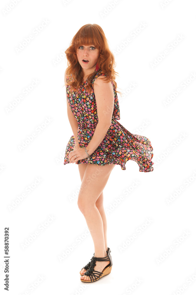 Red haired girl standing in wind isolated over white background Red haired girl standing in wind isolated over white background