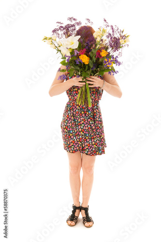 Red haired girl standing with bouquet flowers isolated over whit photo