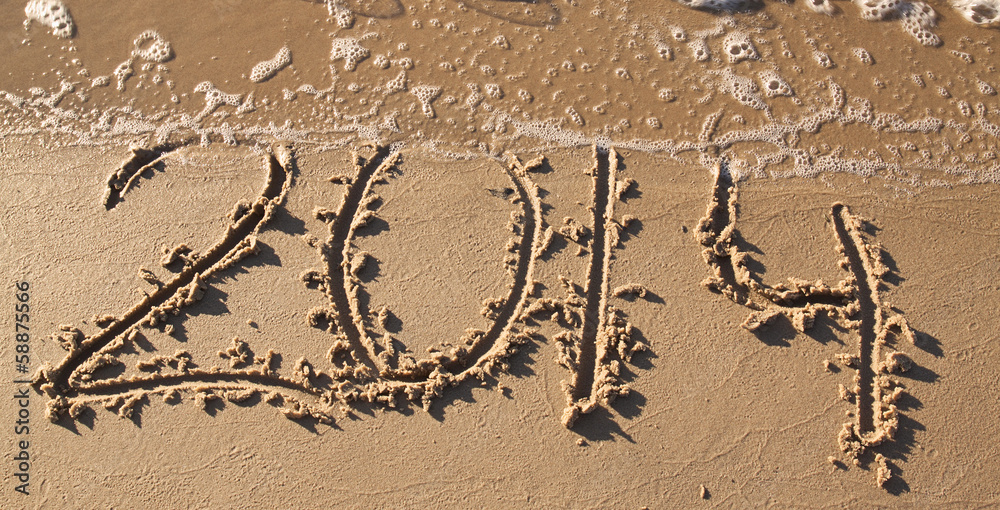 Inscription 2014 on a sandy beach
