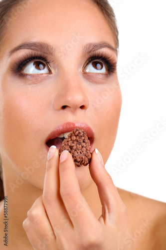 Portrait of beautiful young girl with chocolate candy isolated