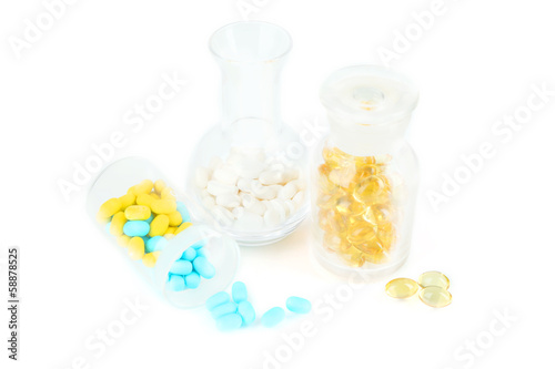 Medical bottles and pills isolated on white