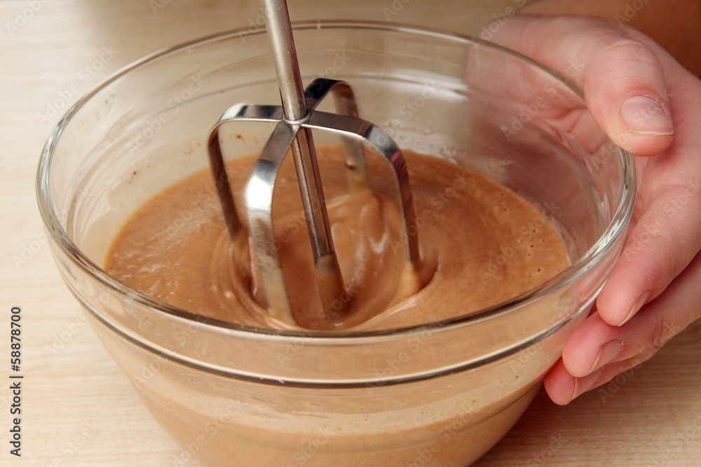 Cooking, whipping eggs with electric whisk in bowl, close up Cooking, whipping eggs with electric whisk in bowl, close up