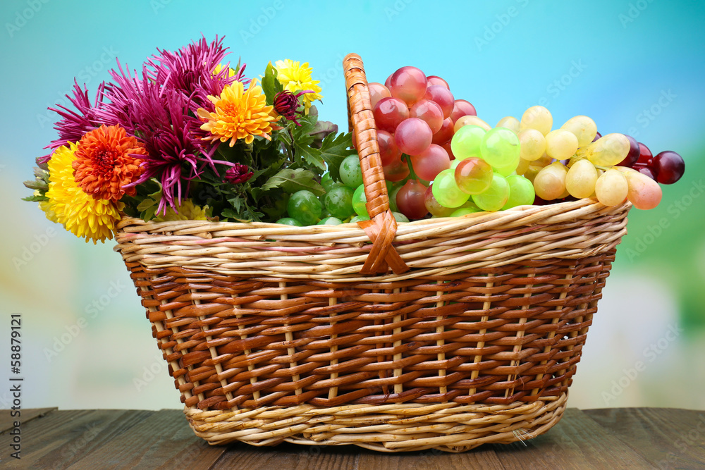Beautiful flowers in wicker basket on bright background Beautiful flowers in wicker basket on bright background
