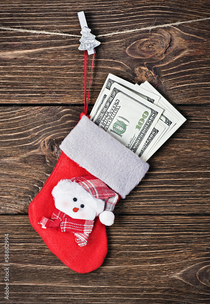 Fototapeta premium Christmas sock with gift dollars