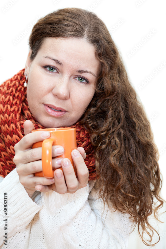 Young sick woman with a cup of tea in her hand isolated on white
