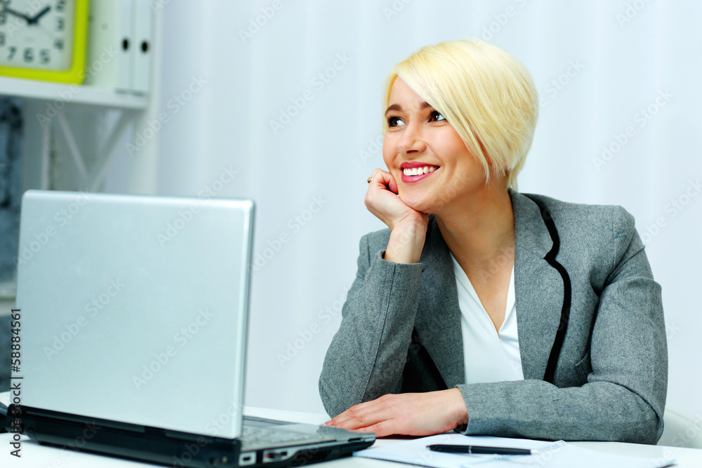 Cheerful businesswoman sitting at the table Cheerful businesswoman sitting at the table