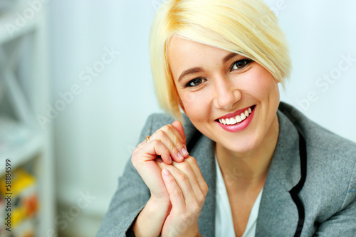 Closeup portrait of a cheerful businesswoman at office